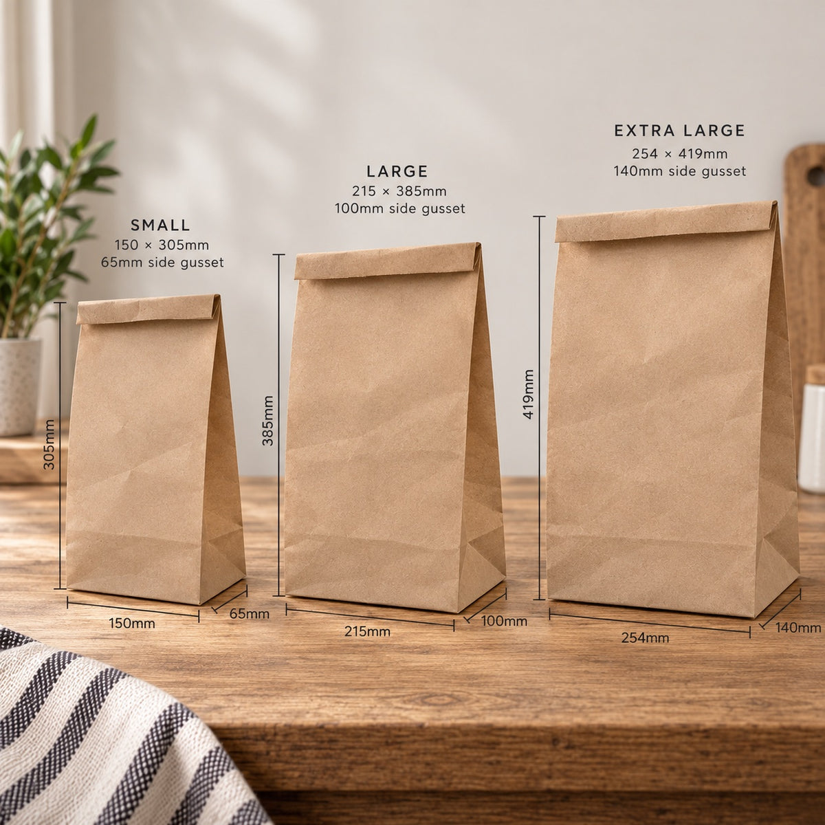 Three brown kraft paper grab bag pouches in small, large, and extra large sizes displayed on a wooden table with printed size measurements and labels.